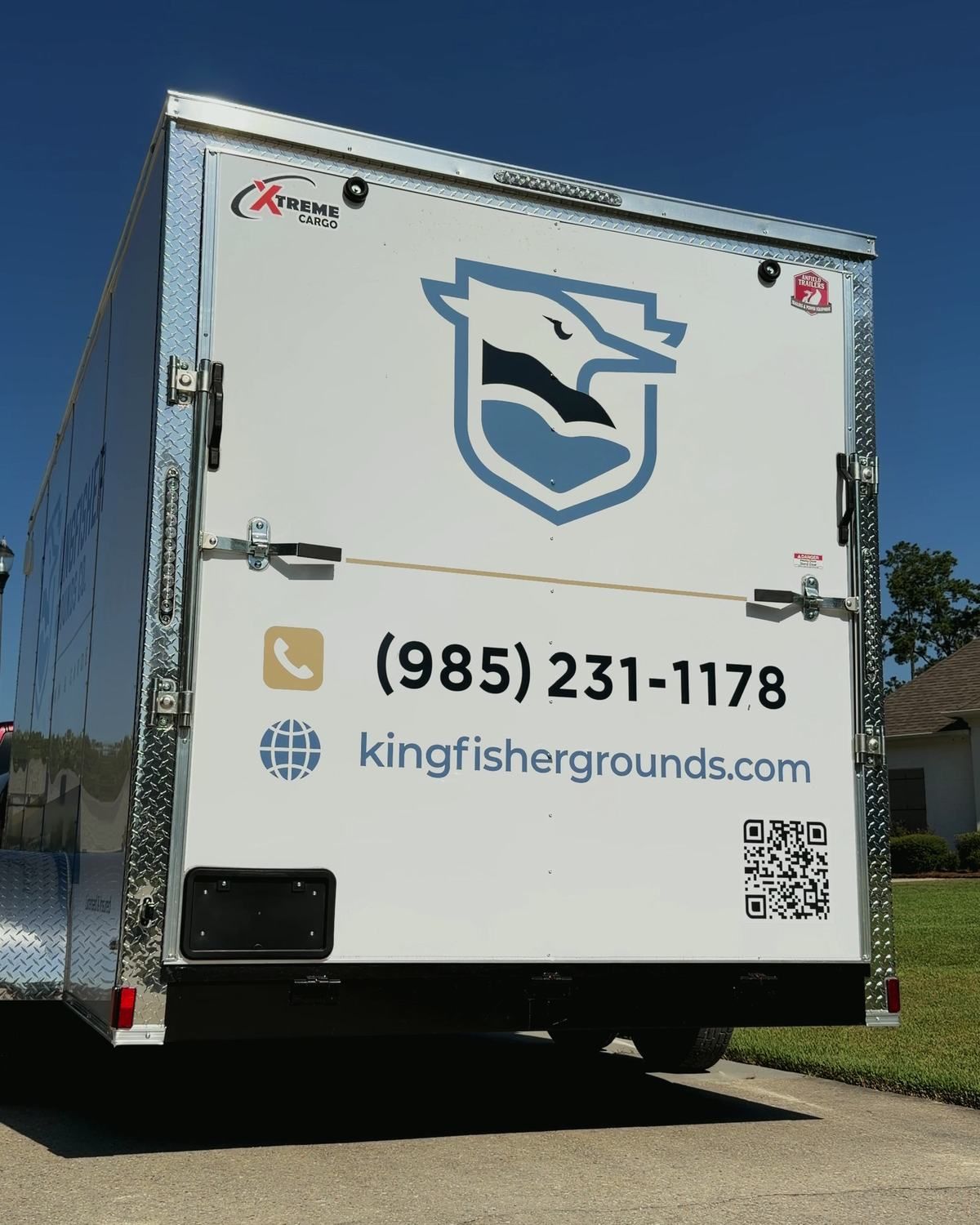 The rear doors of the Kingfisher trailer with the emblem, phone number and website