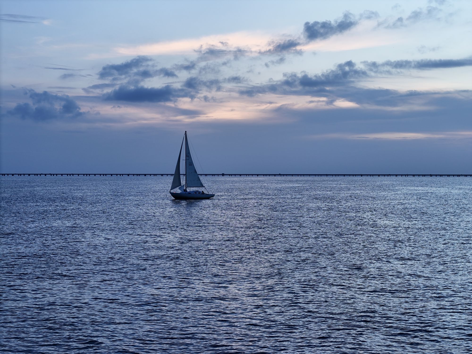 Lake Pontchartrain at the Mandeville lakefront, with the Causeway on the horizon